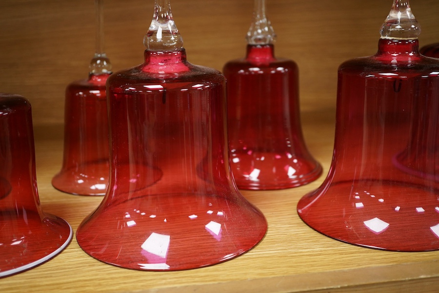 Seven Victorian cranberry glass bells, one with patriotic opaque twist handle, largest 30cm high. Condition - fair/good